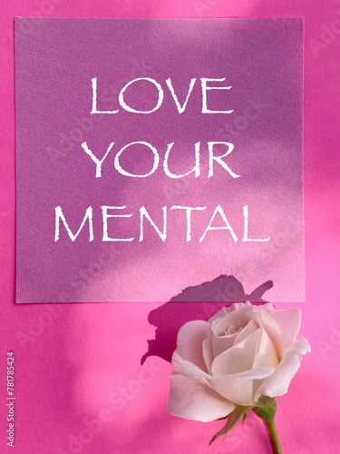 Awareness Concept - love your mental text on pink paper background. Stock photo.