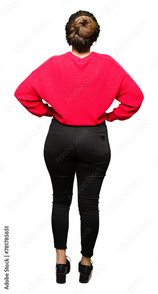 Obraz premium Young beautiful woman wearing red sweater and bun standing backwards looking away with arms on body