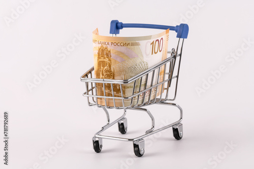 100 Russian ruble banknote in a miniature shopping cart