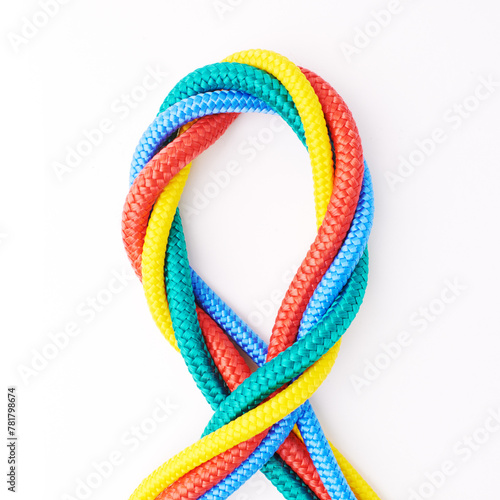 Colorful, ropes and tied for together in studio to represent unity, connect and trust. Secure, string and reef knotted for security to stop movement of objects safety on isolated white background photo