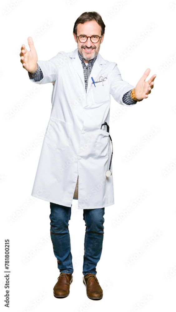 Middle age doctor men wearing medical coat looking at the camera smiling with open arms for hug. Cheerful expression embracing happiness. Middle age doctor men wearing medical coat looking at the camera smiling with open arms for hug. Cheerful expression embracing happiness.