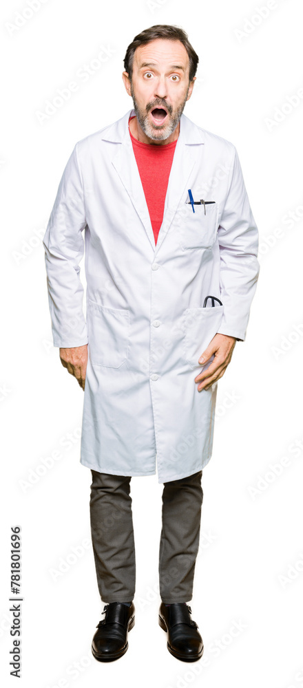 Fototapeta premium Middle age therapist wearing white coat afraid and shocked with surprise expression, fear and excited face.