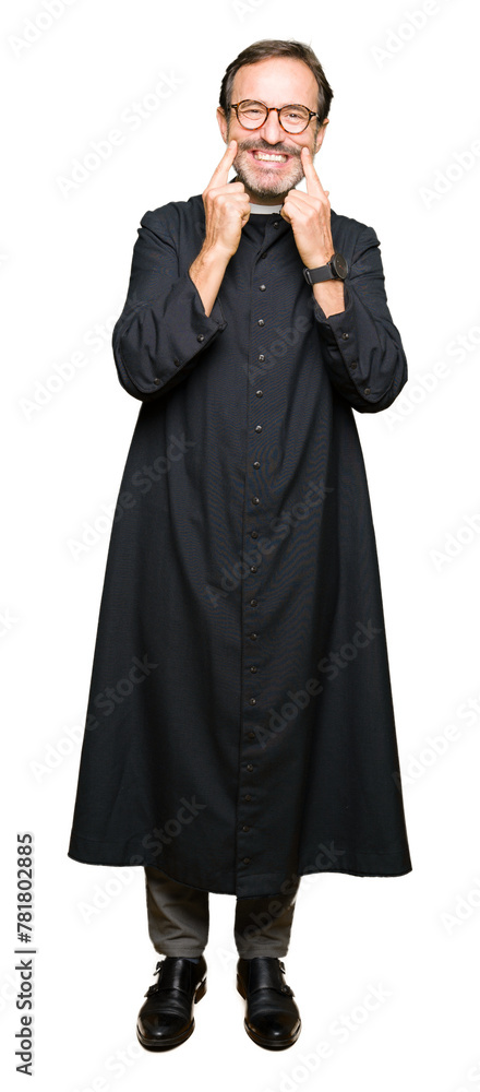 Middle age priest man wearing catholic robe Smiling with open mouth, fingers pointing and forcing cheerful smile Middle age priest man wearing catholic robe Smiling with open mouth, fingers pointing and forcing cheerful smile