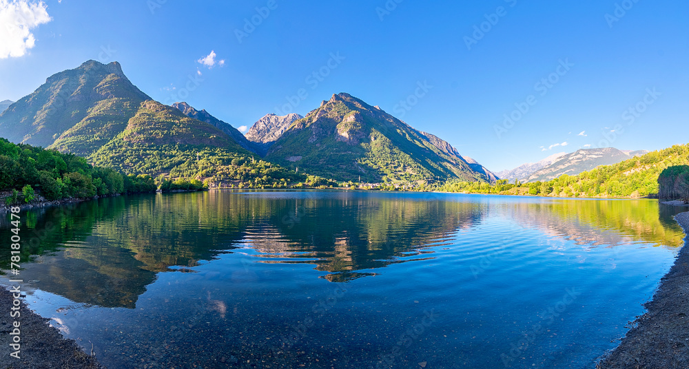 Panoramic view of the Eriste reservoir with the reflection of the mountains. Benasque Valley. Pyrenees. Huesca. Aragon. Spain