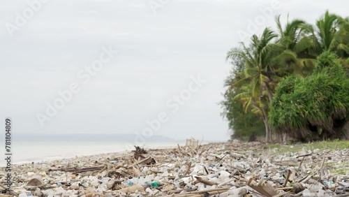 coastal crisis, plastic pollution littering tropical beach, man-made disaster