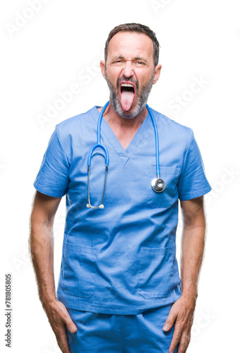 Middle age hoary senior doctor man wearing medical uniform over isolated background sticking tongue out happy with funny expression. Emotion concept. © Krakenimages.com