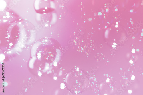 Beautiful Transparent Shiny Soap Bubbles Floating on Pink Background. Celebration Festive Backdrop. Pink Textured. Freshness Soap Suds Bubbles Water.