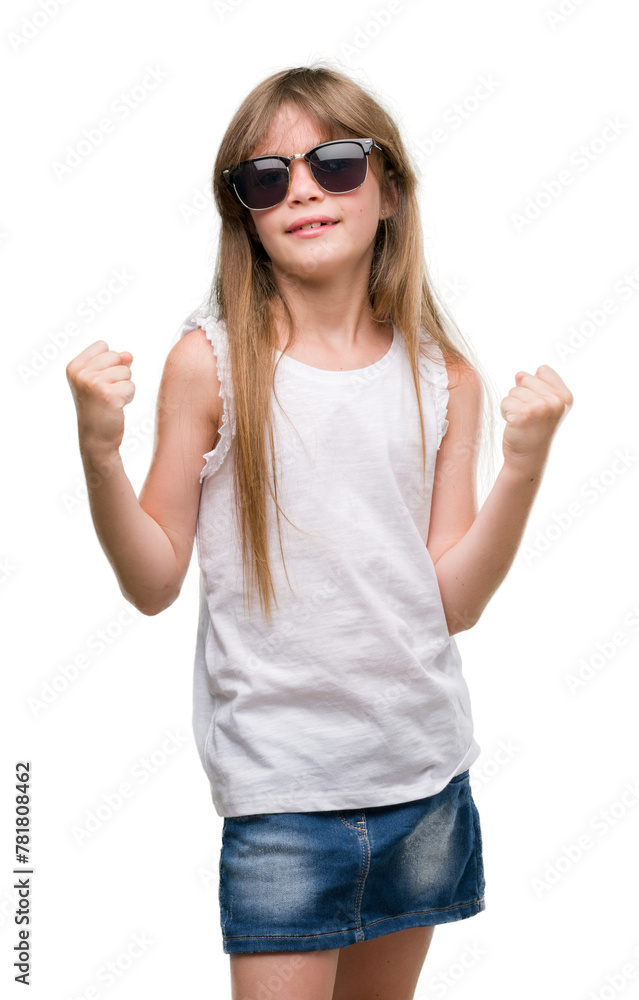 Young blonde toddler wearing sunglasses screaming proud and celebrating victory and success very excited, cheering emotion Young blonde toddler wearing sunglasses screaming proud and celebrating victory and success very excited, cheering emotion
