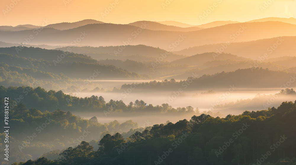 The golden hue of sunrise sets a warm and mystical tone over the foggy forested mountains