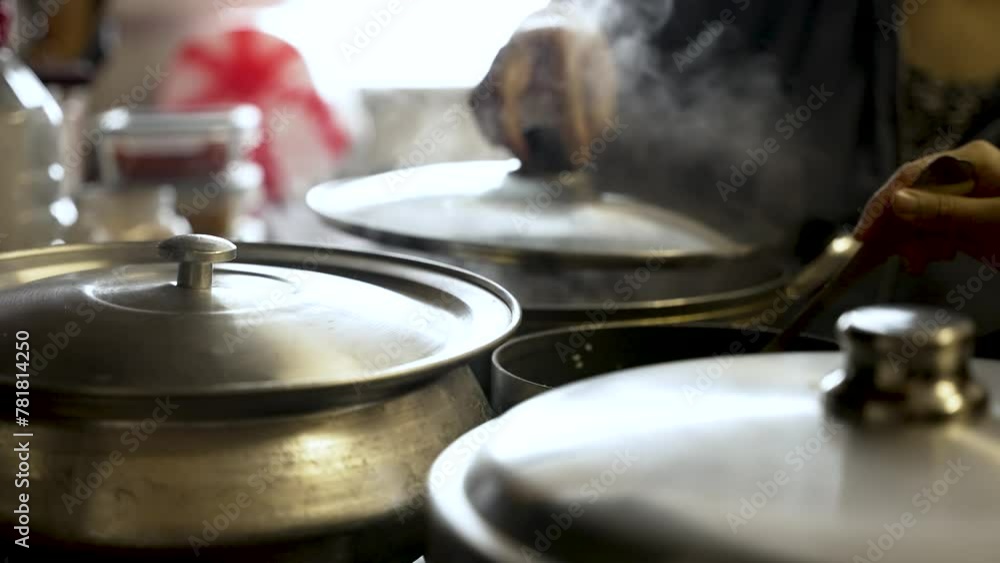 Cooking pots on a stove, individuals lifting lids amid swirling vapor, embodying the essence of culinary artistry and gastronomy. static shot, low angle Cooking pots on a stove, individuals lifting lids amid swirling vapor, embodying the essence of culinary artistry and gastronomy. static shot, low angle