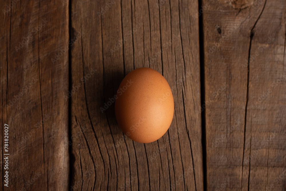 single egg on wooden table