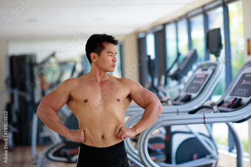 Man exercising in gym. Bodybuilder lifting weights