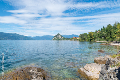 Lake Maggiore, Italy. Beach with clear water and blue sky between the cities of Laveno and Caldè - Castelveccana. Large Italian lake, important travel destination
