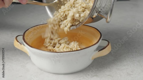 The video shows ready-to-eat oatmeal being poured into a bowl. Perfect for advertising ready-made breakfasts and culinary recipe videos