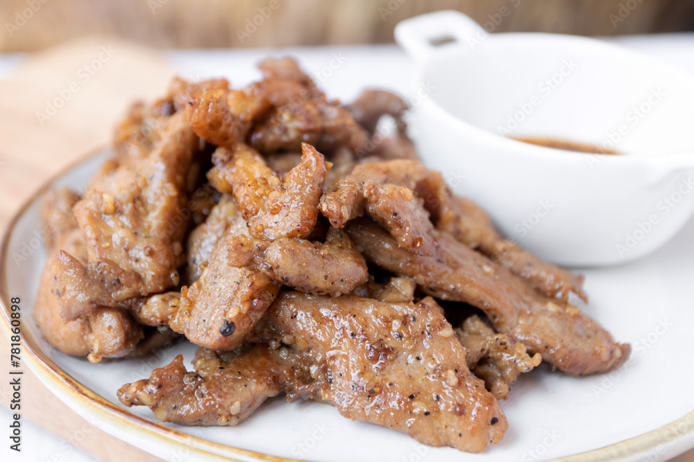 Fried pork with garlic and pepper with Thai spicy dipping sauce (Jaew sauce). Fried pork with garlic and pepper with Thai spicy dipping sauce (Jaew sauce).