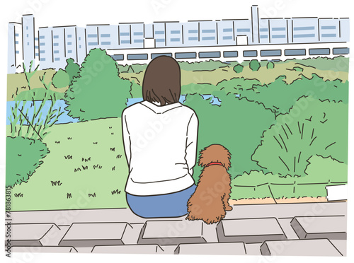 屋外で大自然の中でペットの犬と座る女性