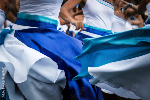 Women dancing maracatu with colorful red and blue dresses in Rio de Janeiro, Brazil during carnival. photo