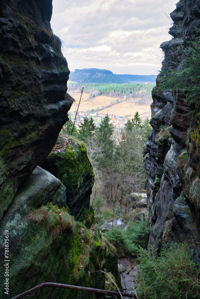 View through a crevice on the ascent to Pfaffenstein. Elbe Sandstone Mountains.