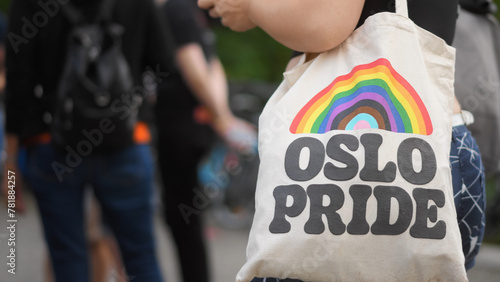 Bi girl hold colorful rainbow bag close-up. Lgbt pride sign. No stop homophobia concept. Gay parade symbol. Free csd love day. People walk coming out party. Cool queer culture flag. Trendy shopper. photo