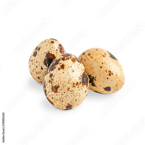 Group of three small whole uncooked raw quail eggs with shell of beige colour and brown spots and speckles isolated on white background used as healthy food ingredient in culinary full of protein