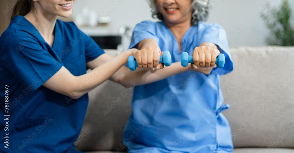 senior woman doing exercise at clinic with physiotherapist. help of a personal trainer during a rehabilitation session. senior woman doing exercise at clinic with physiotherapist. help of a personal trainer during a rehabilitation session.