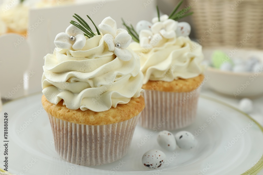 Tasty Easter cupcakes with vanilla cream on table, closeup Tasty Easter cupcakes with vanilla cream on table, closeup