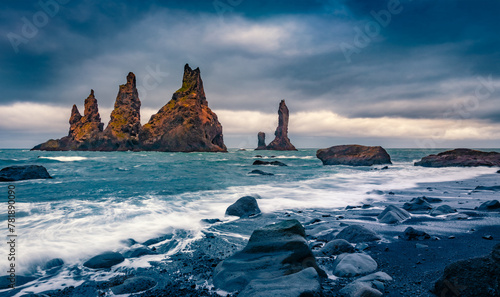 Gloomy morning view of Reynisdrangar cliffs. Picturesque summer seascape of Atlantic ocean. Spectacular outdoor scene of black sand beach in Iceland, Vik location. Travel the world..