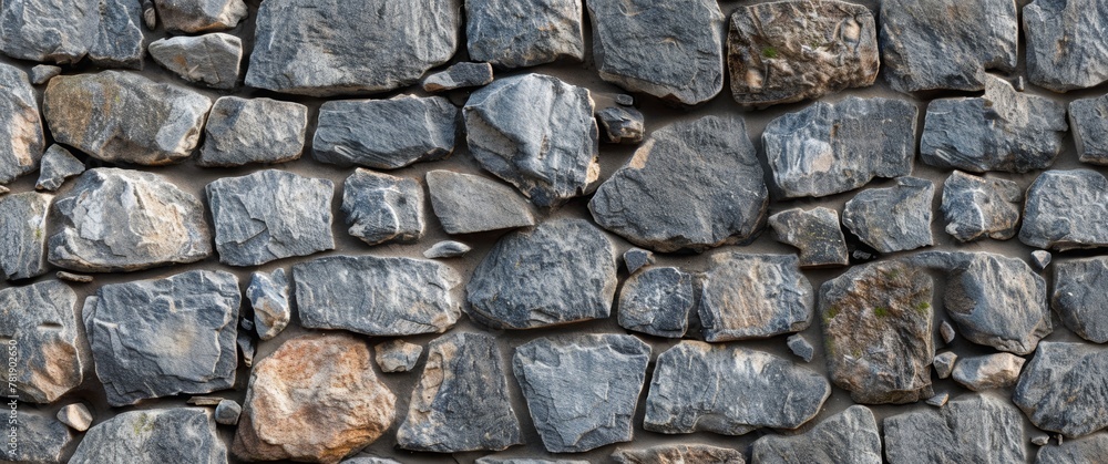 Stones and rocks on the wall. Stone background. Colorful stone wall background with natural rock texture. Top view of rough grey and brown decorative granite rocks in an outdoor landscape design.