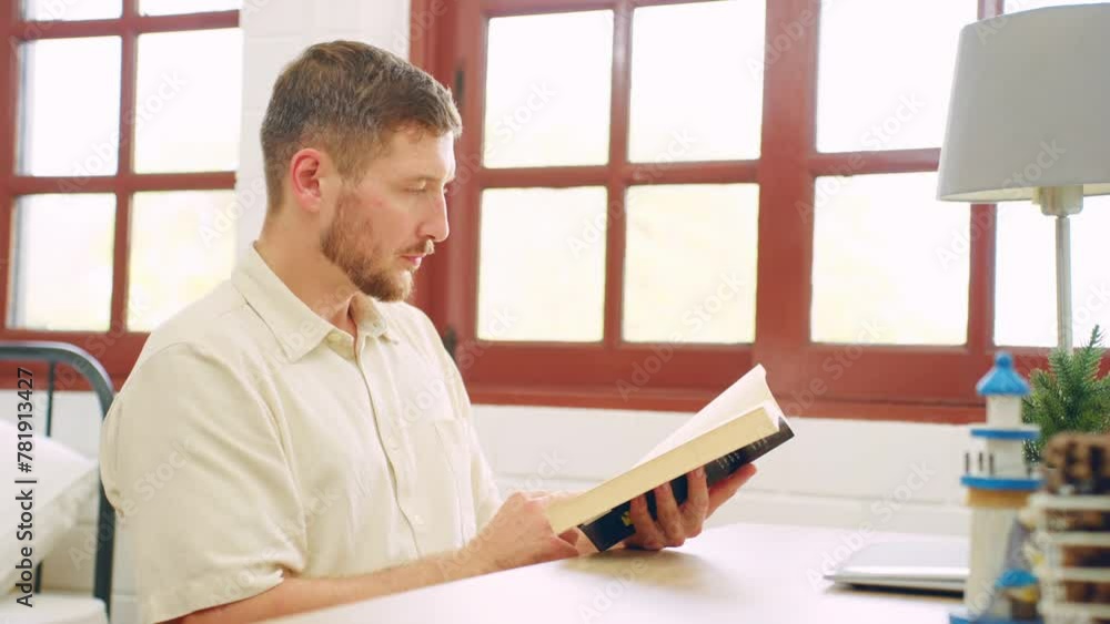 Caucasian young man reading an education book in the bedroom at home. Caucasian young man reading an education book in the bedroom at home.
