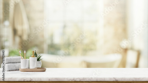 Toiletries on a luxury white marble tabletop with a blurred background of a luxury bathroom.