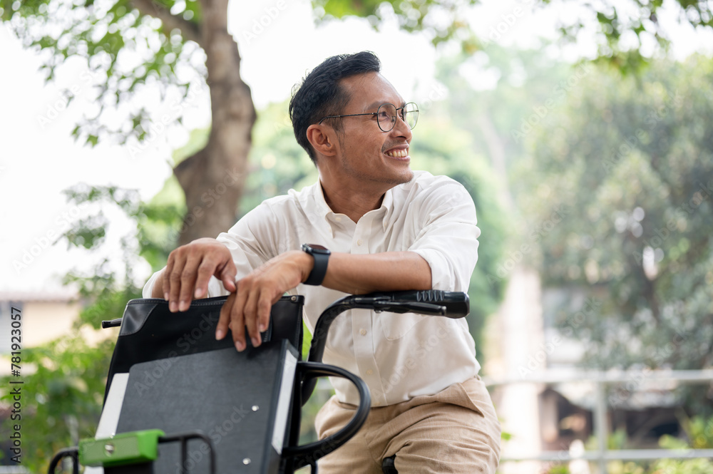 A handsome, happy Asian millennial businessman is on a bike in the park, riding a bike to work. A handsome, happy Asian millennial businessman is on a bike in the park, riding a bike to work.