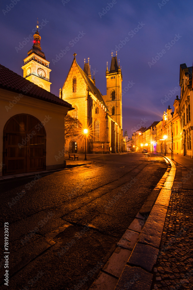 A magical winter night in the center of the city of Hradec Králové with the light of street lamps and reflections on the sidewalks after the rain