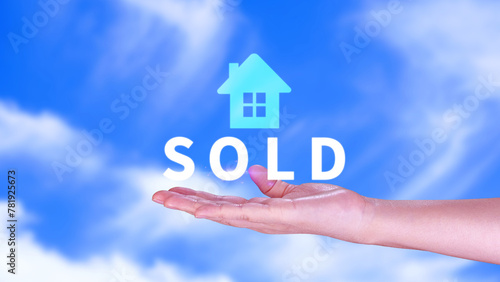 Realtor s hand puts with icon house and word SOLD. Concept of selling house  apartment  real estate. market of immobility  Property investment and house mortgage financial concept