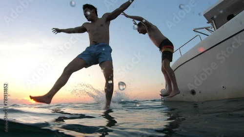 Group of young friends jumping to the beach, having a party in yacht. 