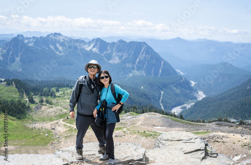 Couple posing for photos at Skyline Trail. Mt Rainier National Park. Washington State.