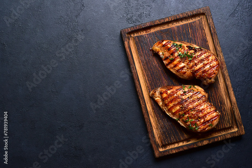 Grilled spicy chicken breasts. Top view with copy space.