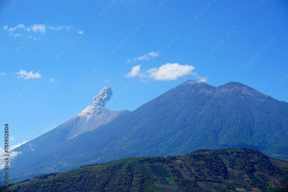 Fototapeta premium Aerial view of mountain landscape surrounded by dense trees