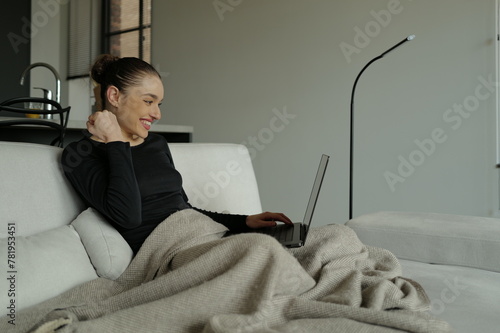 excited young woman working on laptop computer working from home and celebrating success