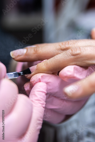 Applying nail polish at a professional manicure session