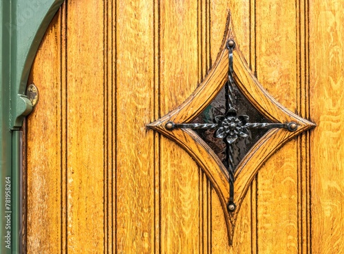 Closeup of a peephole in old wooden front door