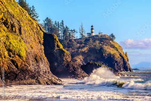 Lighthouse on the cliffy seashore photo
