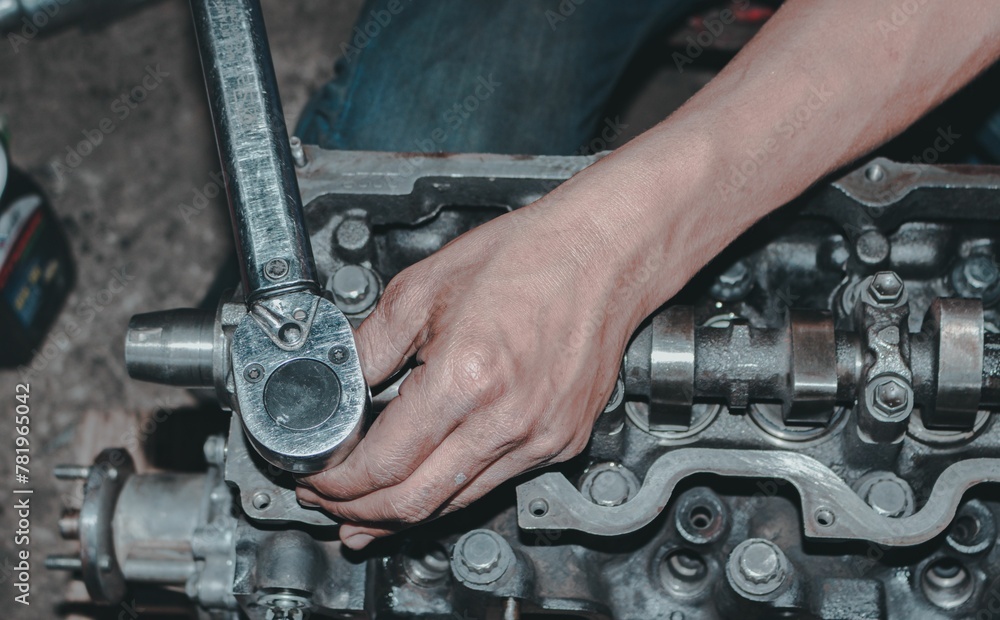 Closeup of a worker fixing an internal combustion engine Closeup of a worker fixing an internal combustion engine