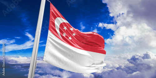 Singapore national flag cloth fabric waving on beautiful Blue Sky Background.