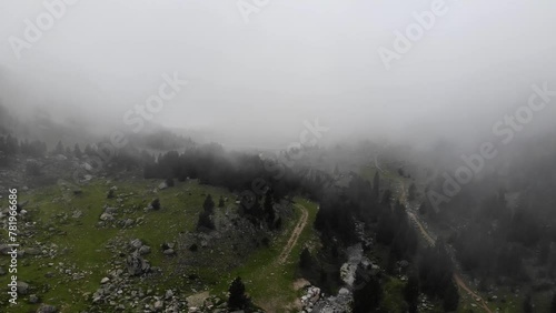 Aerial Drone Footage over dense fog in the forest in Pyrenees mountains. Baqueira Beret. Catalonia, Spain