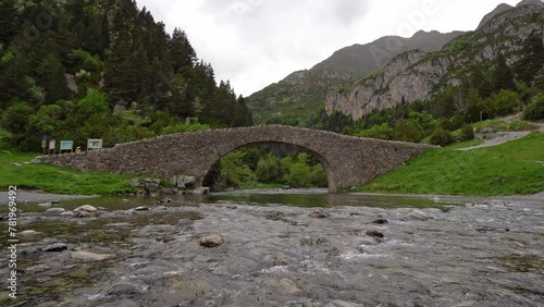 Water flows under the romanesque Bridge of San Nicolás de Bujaruelo, in Ordesa y Monte Perdido National Park, Huesca, Aragon, Spain