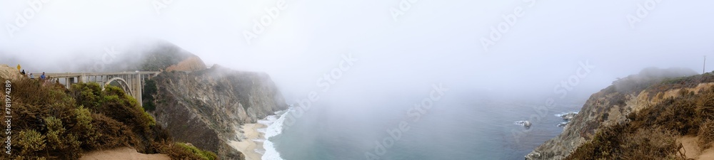 Panoramic shot of the Big Sur covered in the fog and clouds in California