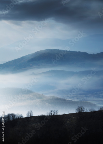 mysterious landscape with hills in fog