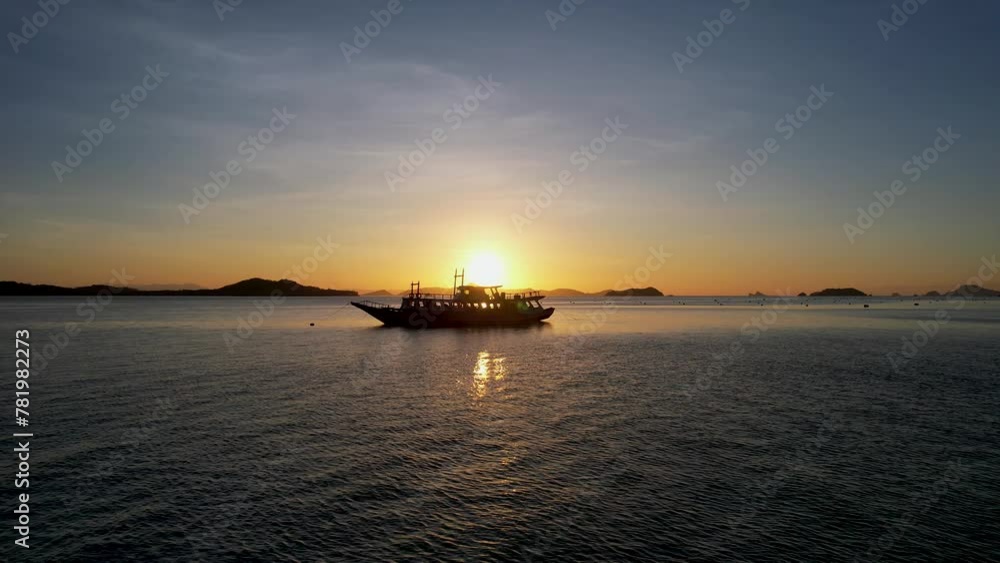 Traditional philippine boat bangka at sunset time in Linapacan, Philippines. Orange sky sunset paradise beach.