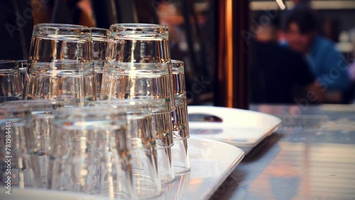 Fototapeta Naklejka Na Ścianę i Meble -  Selective focus shot of clean glasses on a tray in a bar