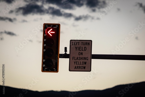 Closeup shot of a traffic light and sign indicating 